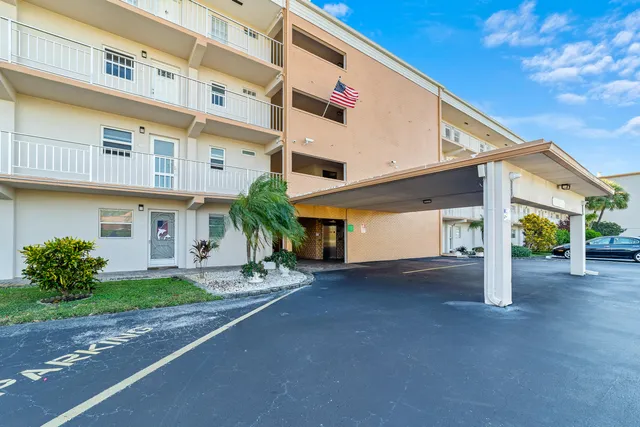 a view of a house with a yard and garage