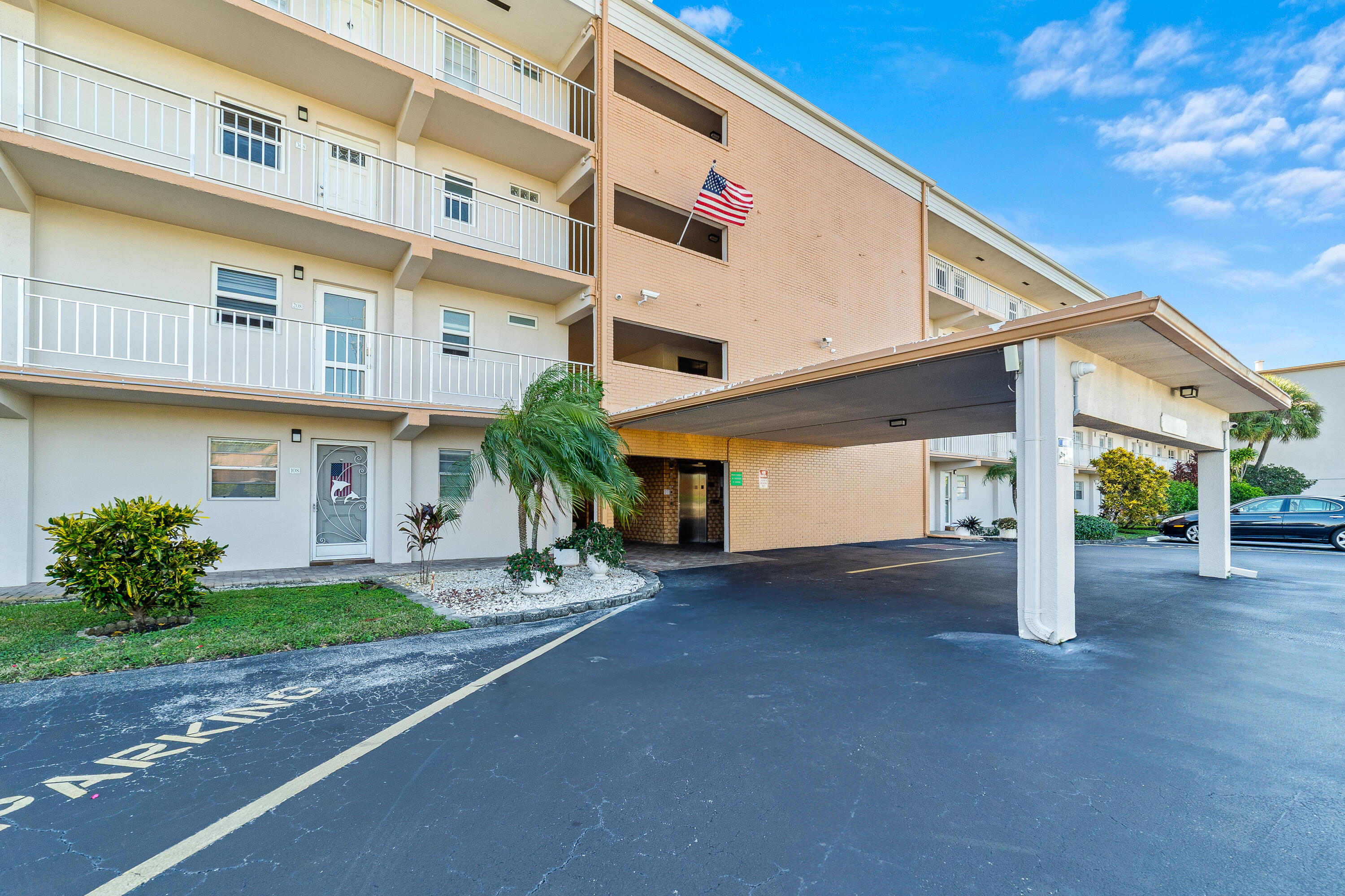 230 Northeast 26th Avenue, Unit 3020 Boynton Beach, FL 33435 - Photo 27 of 44 a view of a house with a yard and garage