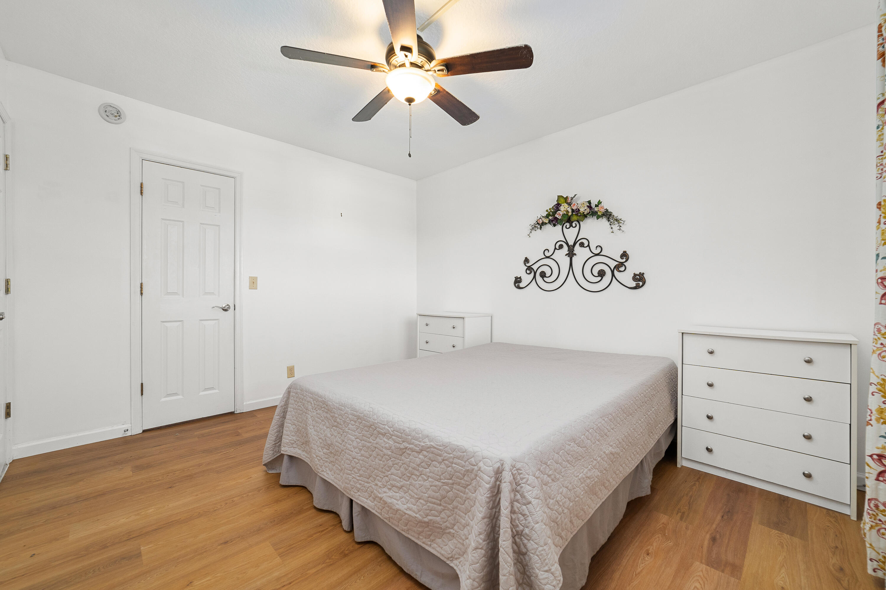 230 Northeast 26th Avenue, Unit 3020 Boynton Beach, FL 33435 - Photo 30 of 44 a bedroom with a bed and a chandelier