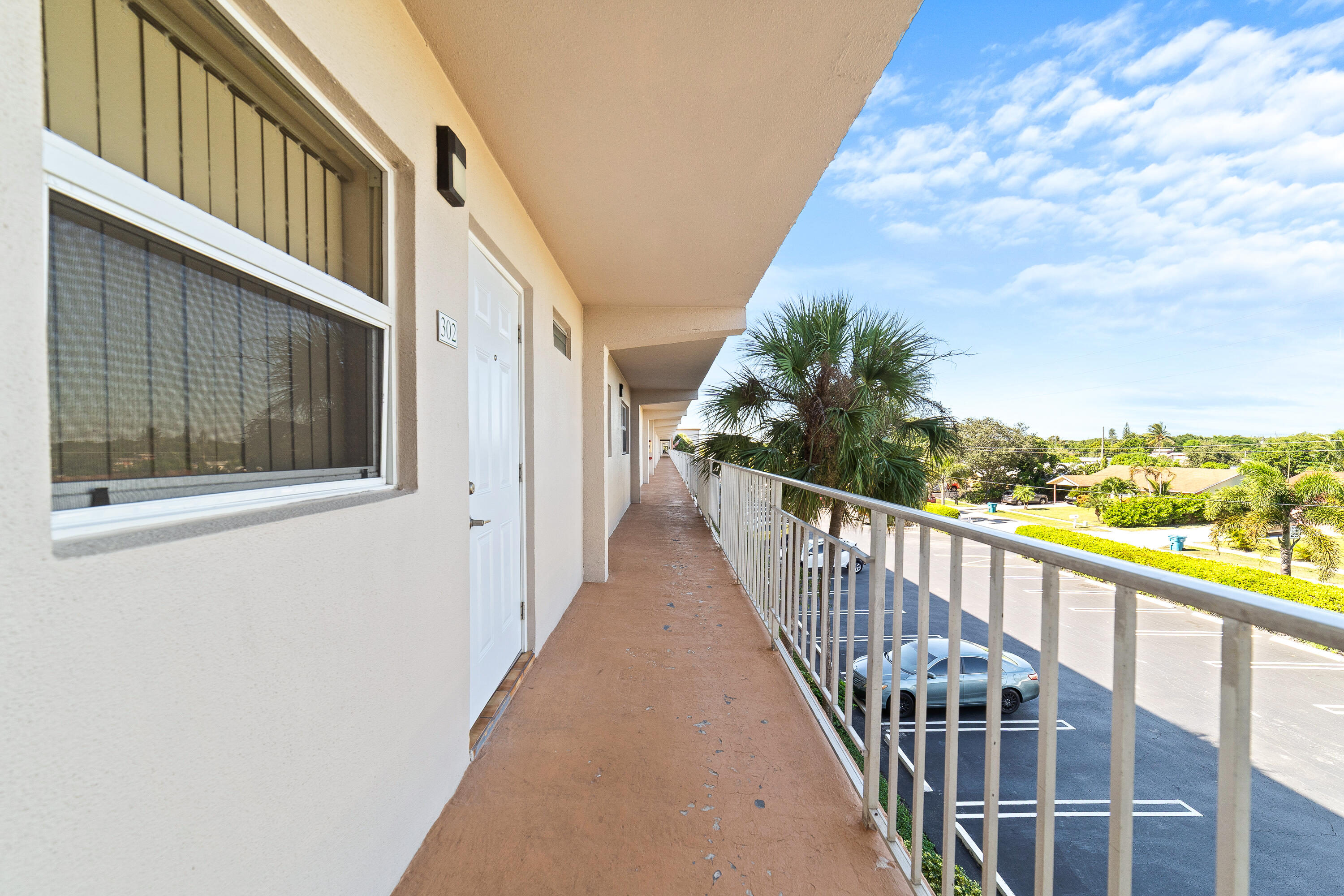 230 Northeast 26th Avenue, Unit 3020 Boynton Beach, FL 33435 - Photo 3 of 44 a view of a balcony with wooden floor and fence