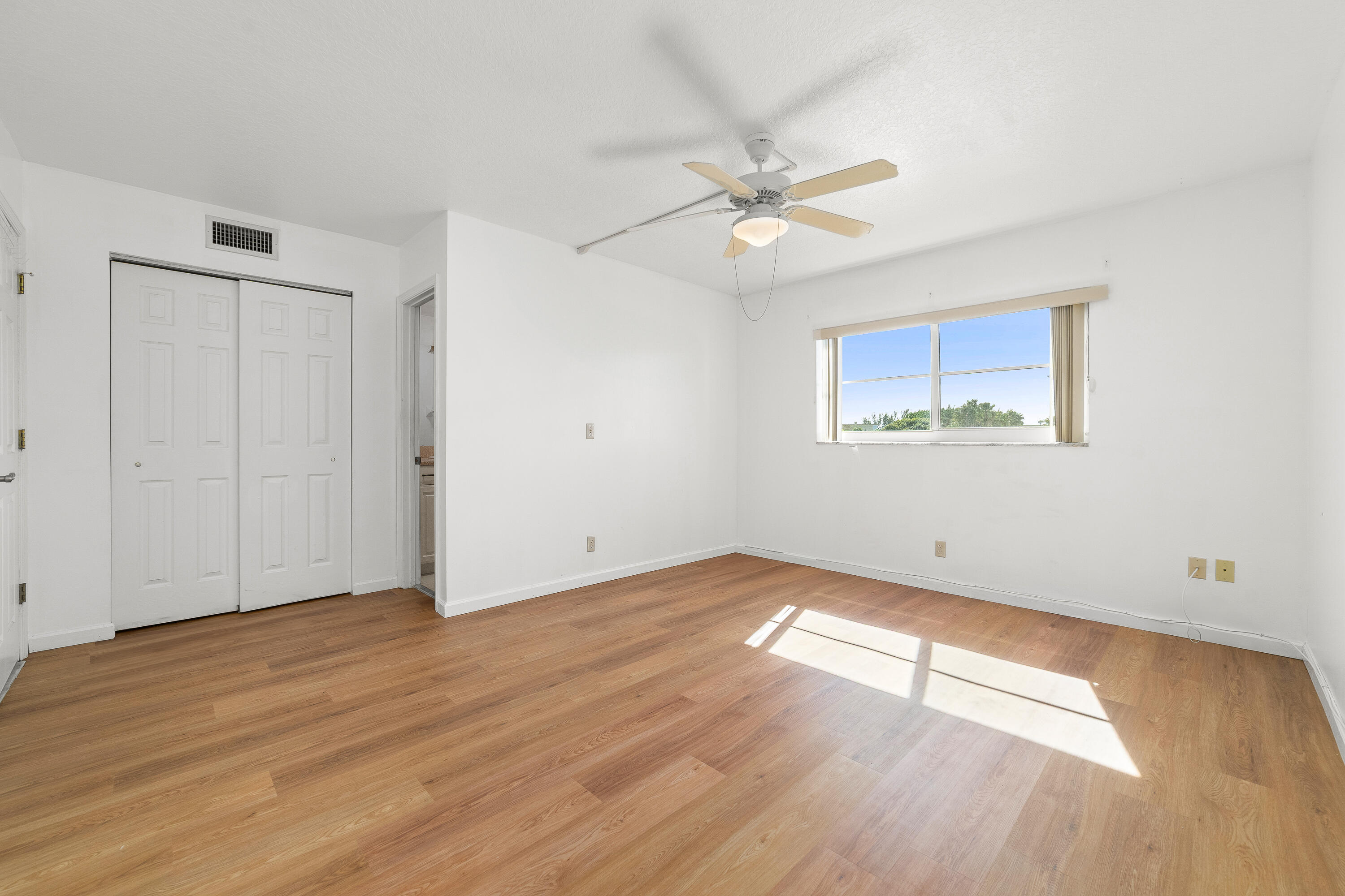 230 Northeast 26th Avenue, Unit 3020 Boynton Beach, FL 33435 - Photo 34 of 44 wooden floor in an empty room with a window