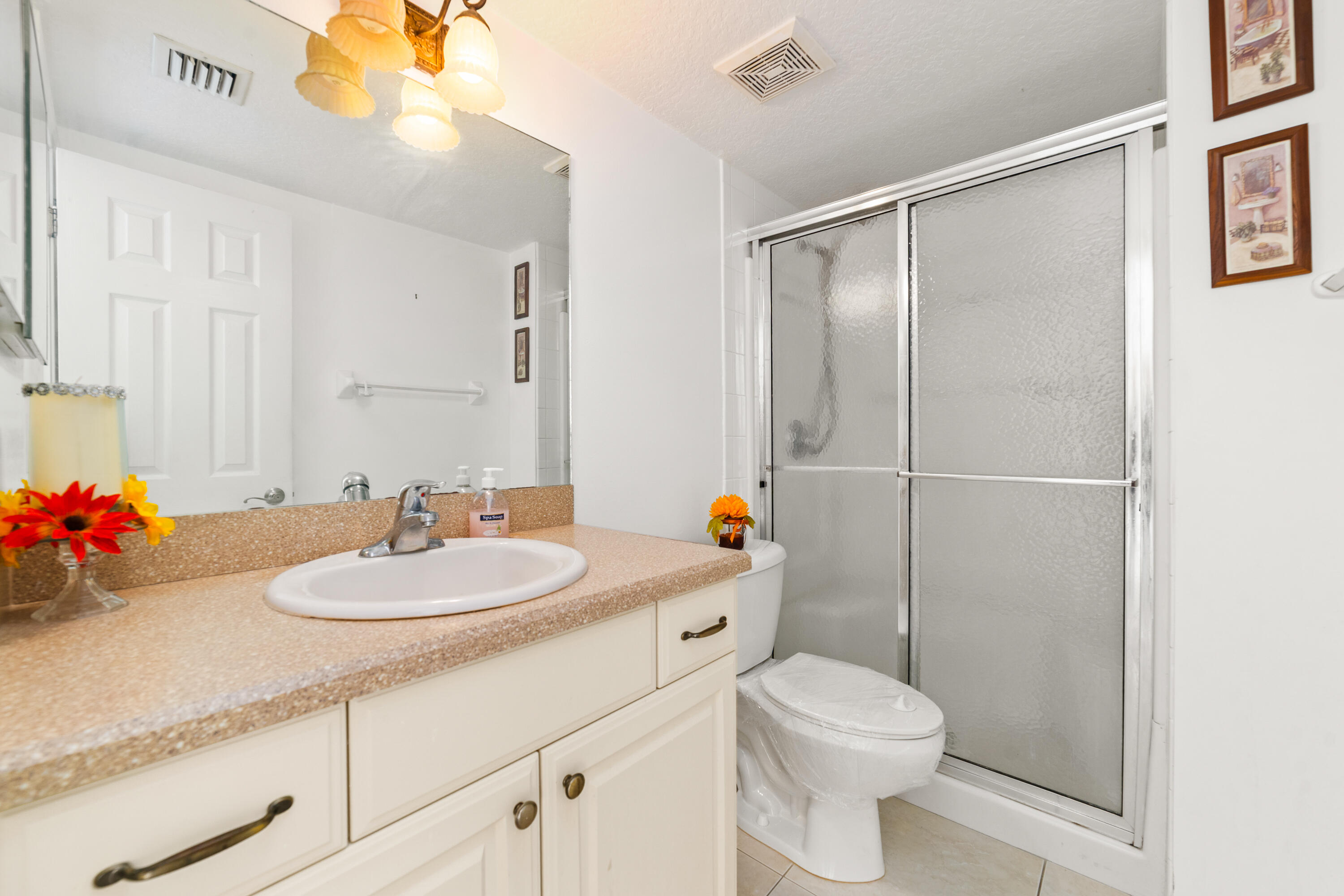 230 Northeast 26th Avenue, Unit 3020 Boynton Beach, FL 33435 - Photo 36 of 44 a bathroom with a sink toilet and shower