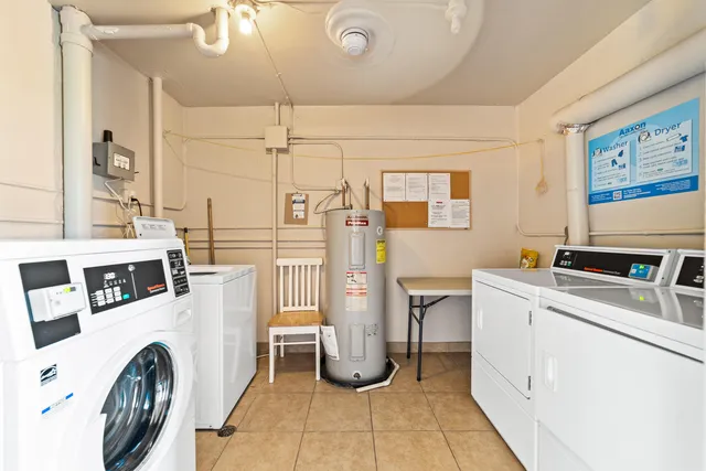 a utility room with multiple dryer and washer