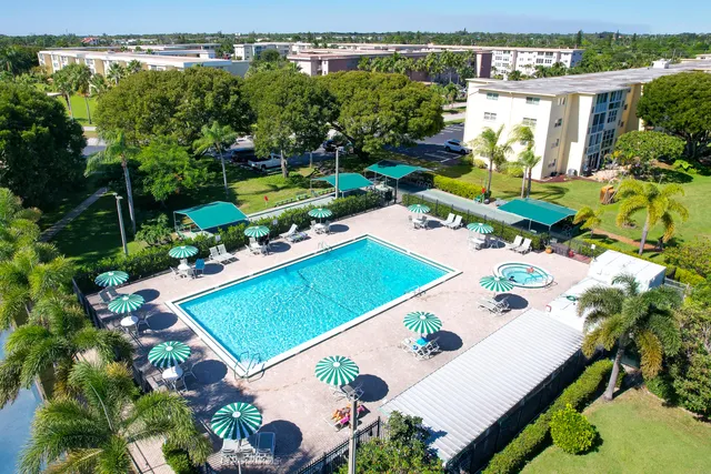 an aerial view of a house with a garden and swimming pool