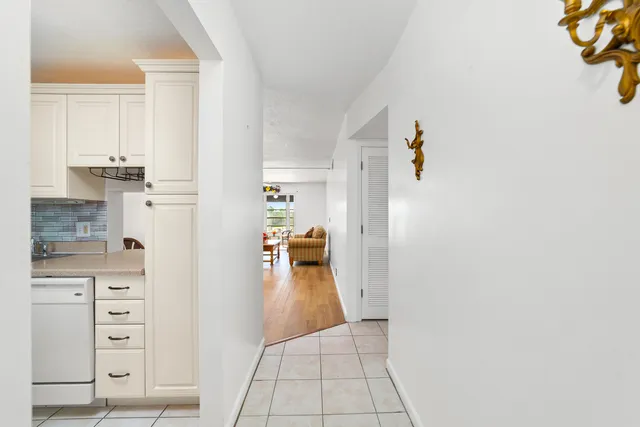 walk in closet with white cabinets
