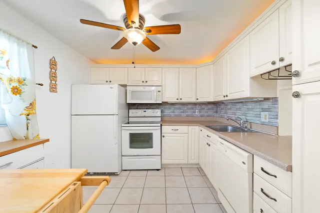 a kitchen with a refrigerator a sink and dishwasher
