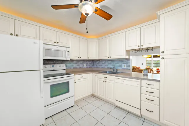 a kitchen with cabinets stainless steel appliances and a counter space