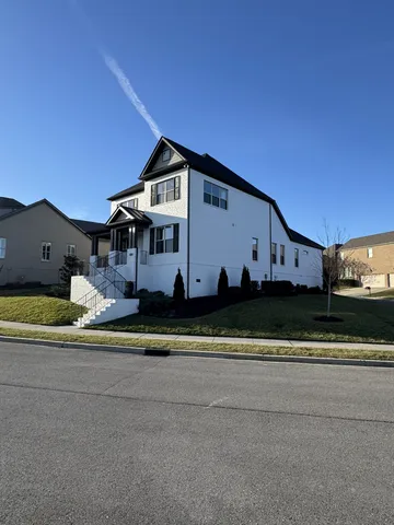 a front view of a house with a big yard