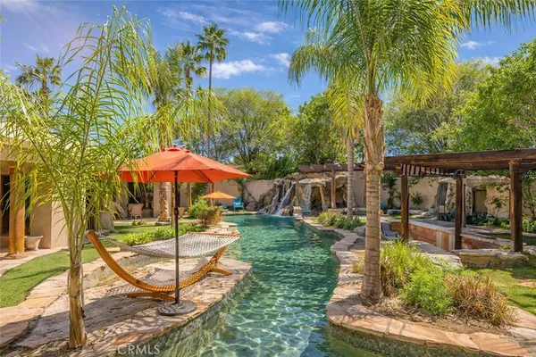 a view of a backyard with plants and patio