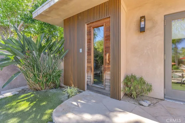 a view of a house with a yard and sitting area