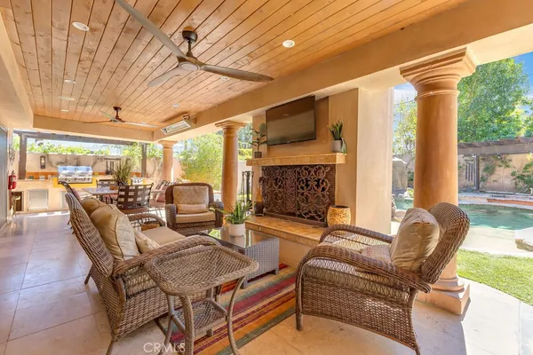 a living room with furniture gym equipment and a large window