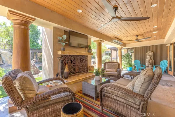 a living room with furniture and a potted plant