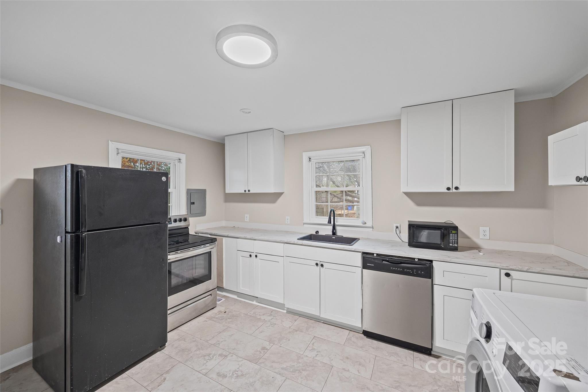 1315 Eisenhower Road Rock Hill, SC 29732 - Photo 14 of 21 a kitchen with a refrigerator sink and cabinets