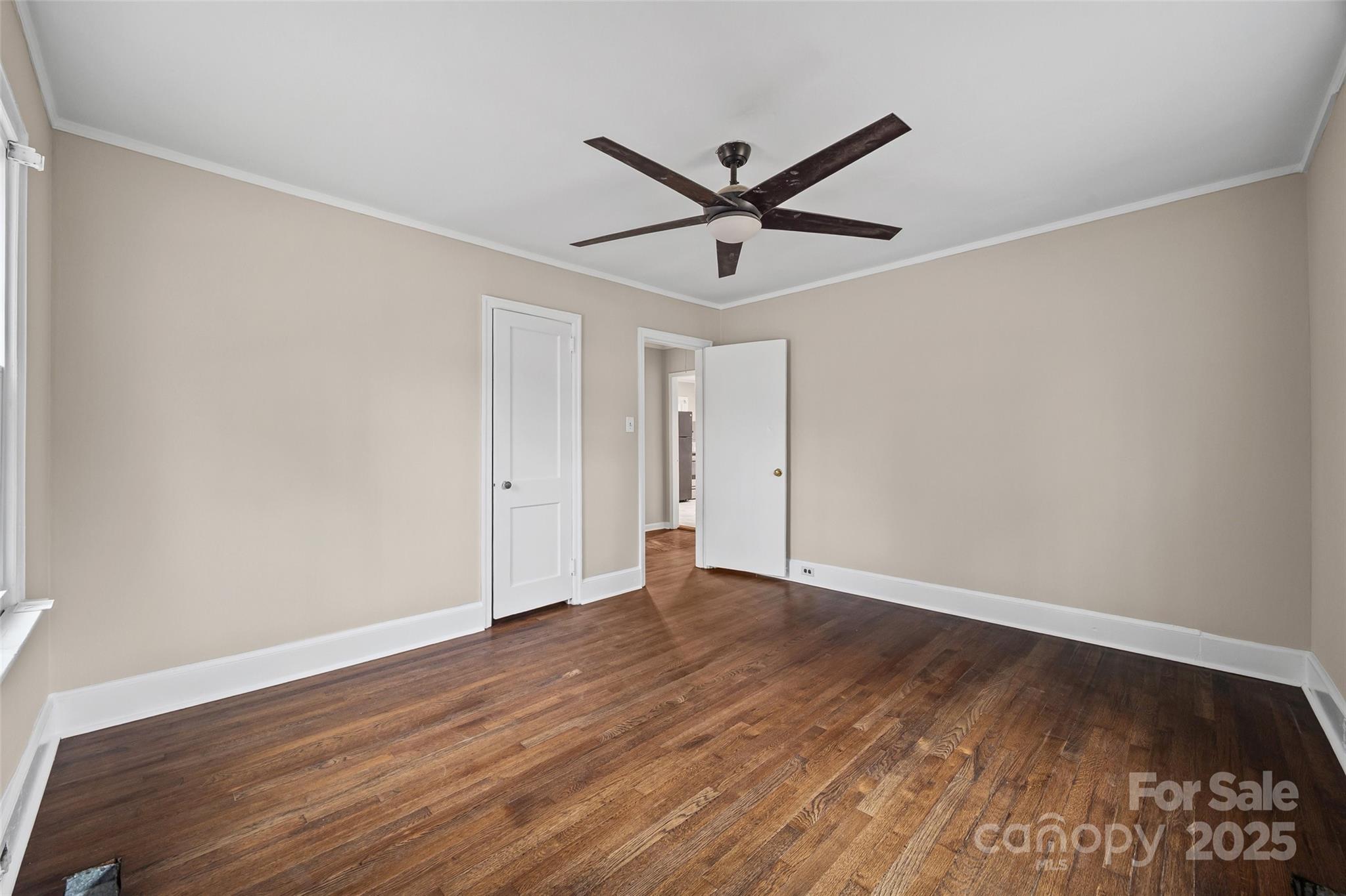1315 Eisenhower Road Rock Hill, SC 29732 - Photo 10 of 21 a view of an empty room with wooden floor and a ceiling fan