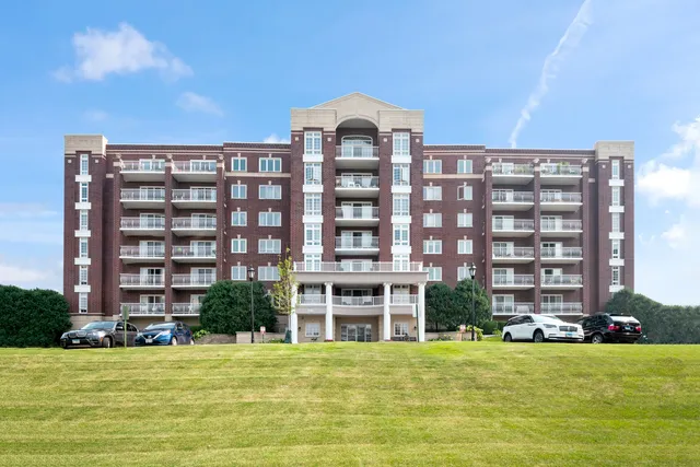 a front view of a building with a garden