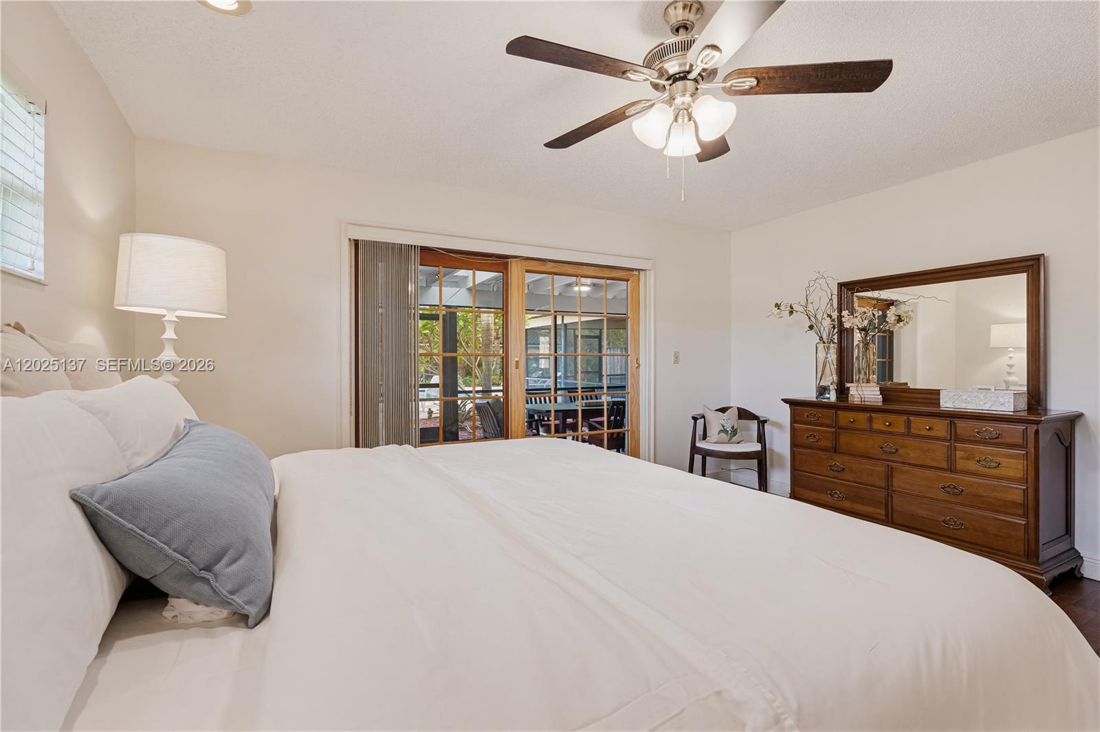 11480 Southwest 96th Terrace Miami, FL 33176 - Photo 29 of 54 a bedroom with a large bed and a chandelier fan
