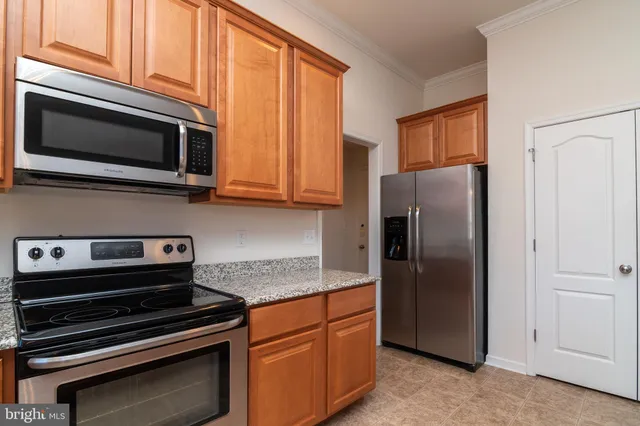 a kitchen with granite countertop cabinets and window