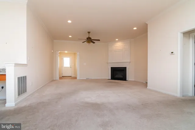 a view of an empty room with a fireplace