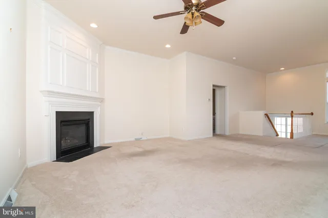 a bed sitting in a bedroom next to a window and a chandelier