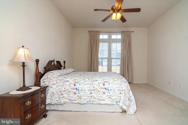 a bathroom with a tub a mirror and a shower