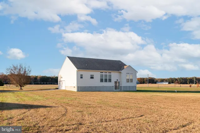 a view of house with yard and ocean view