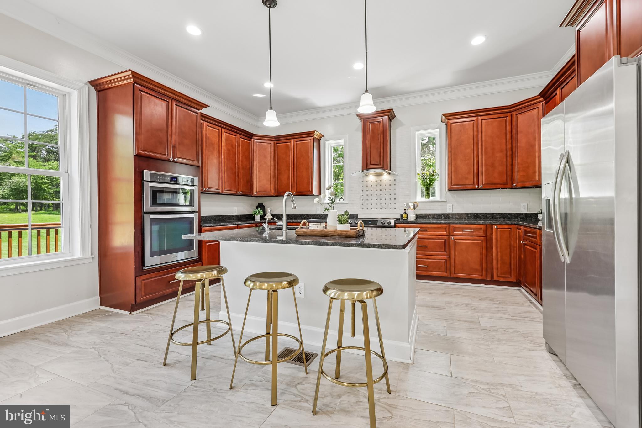 12304 Popes Head Road Fairfax, VA 22030 - Photo 4 of 78 a kitchen with stainless steel appliances granite countertop a stove a refrigerator a oven a sink with a dining table and chairs