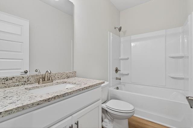 2562 Harbor Ridge Pass Gainesville, GA 30507 - Photo 18 of 27 a bathroom with a granite countertop sink a toilet and a bathtub
