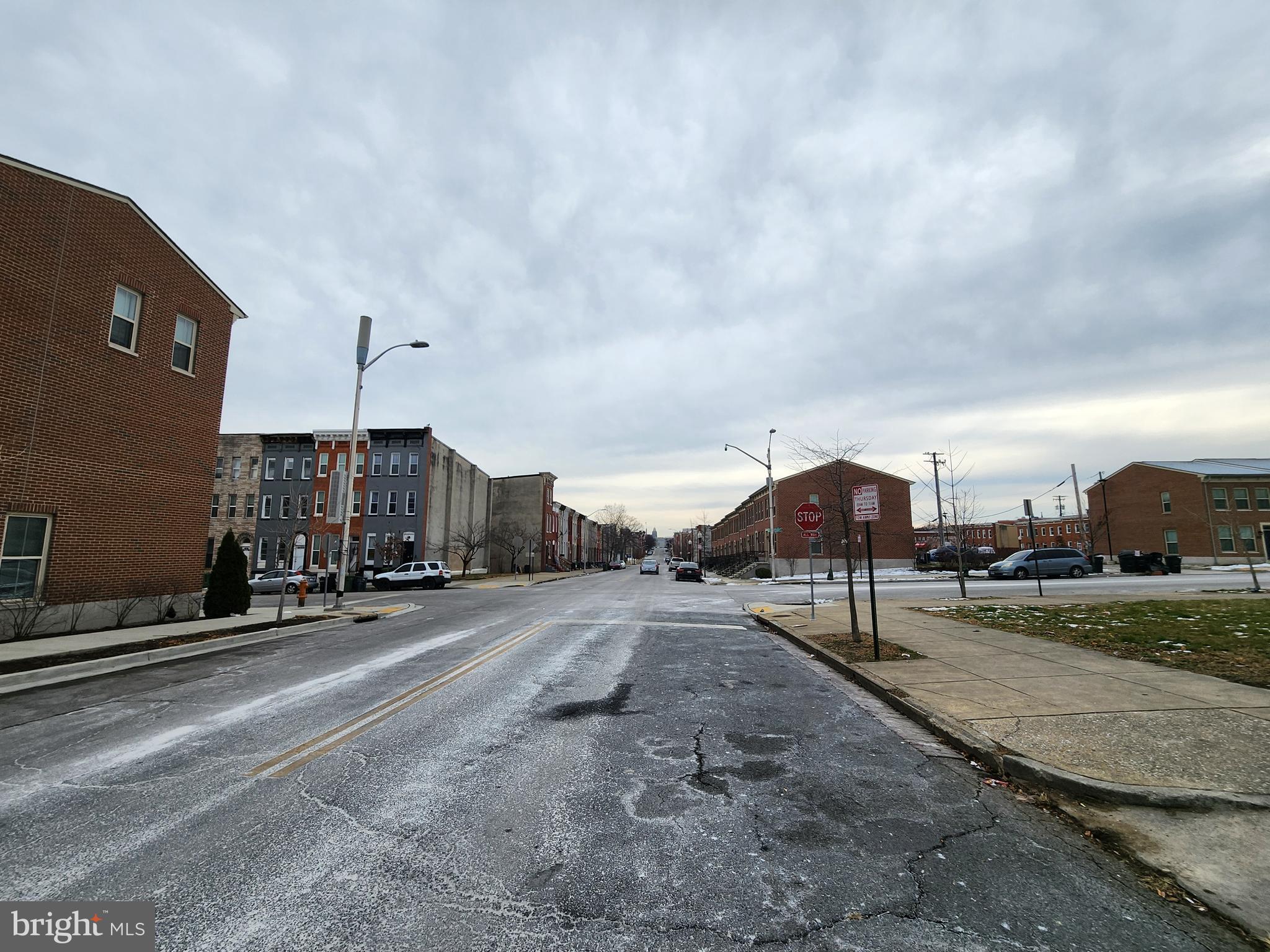 1902 Division Street Baltimore, MD 21217 - Photo 6 of 7 a view of a street with houses in the background