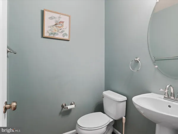 a white toilet sitting next to a bathroom sink