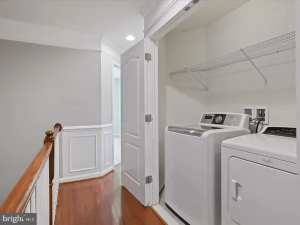 a view of washer and dryer with kitchen in the background