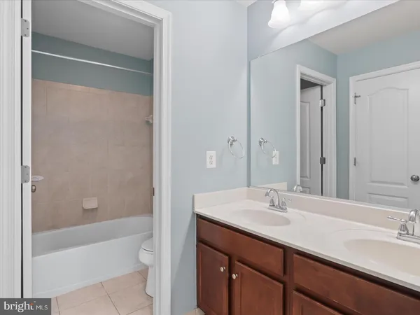 a bathroom with a sink shower and a mirror
