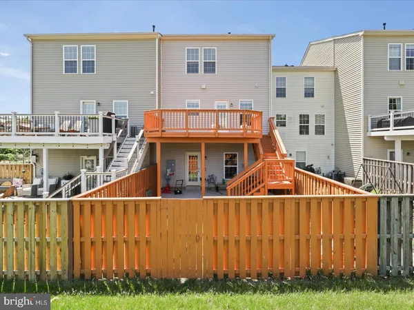 a view of a house with a yard and potted plants