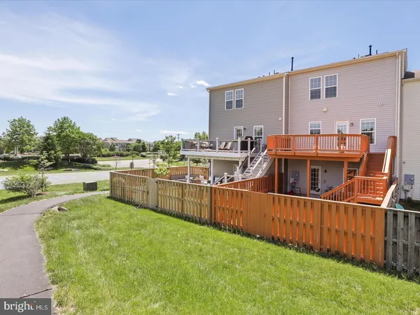 a view of a house with pool and chairs