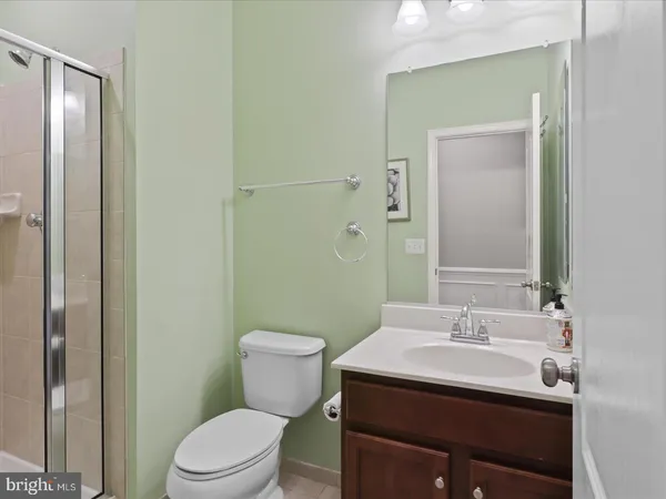 a bathroom with a sink toilet and mirror