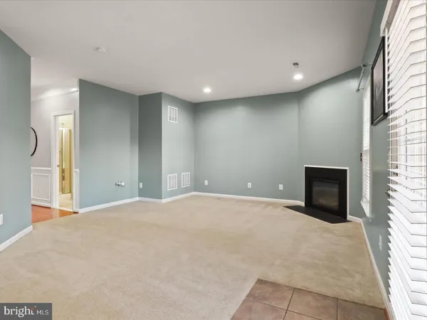 a view of an empty room with a fireplace