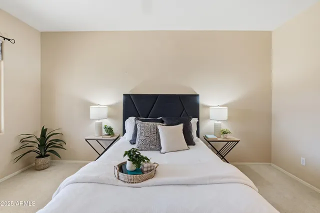 a bedroom with a bed and a night stand