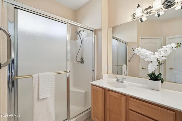 a bathroom with a double vanity sink mirror and shower