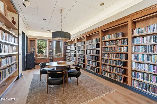 a dining room with furniture and a book shelf
