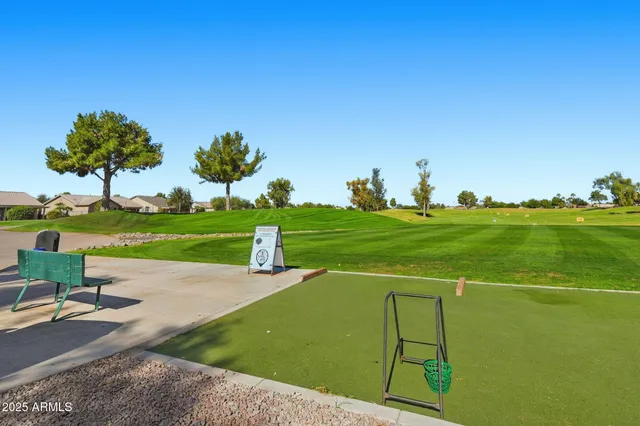 a view of a golf course with chairs