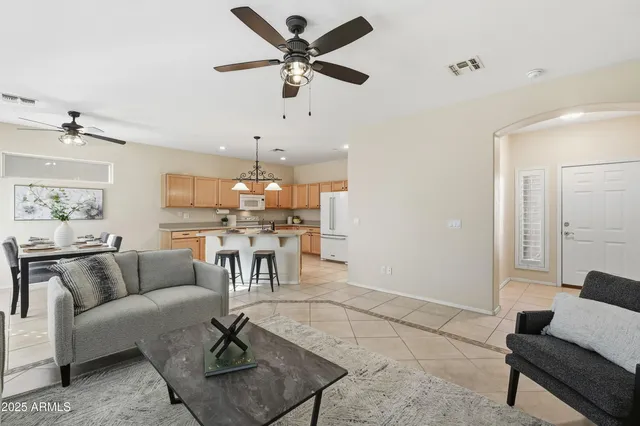 a living room with furniture and a view of kitchen
