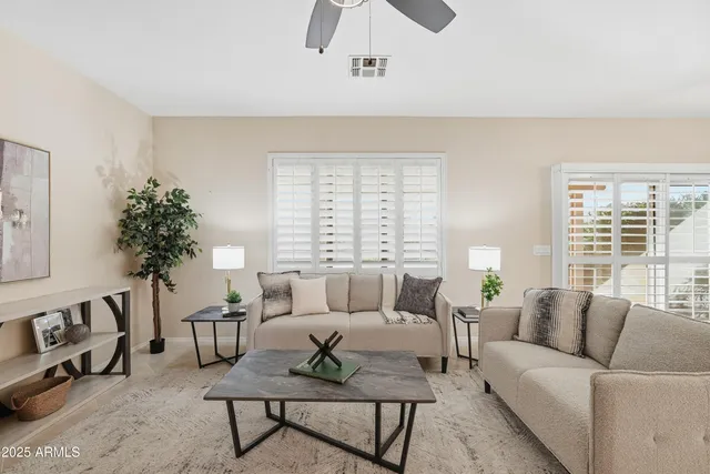 a living room with furniture and a large window
