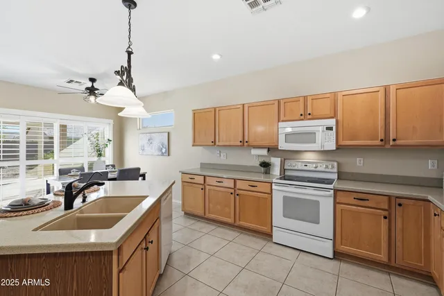 a kitchen with stainless steel appliances granite countertop a sink and cabinets