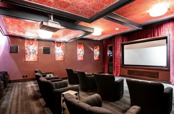a media room with lots of chairs and a projector