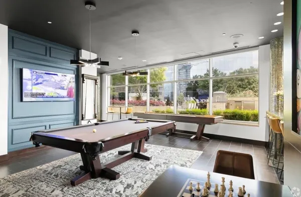 a living room with lots of furniture and a large window