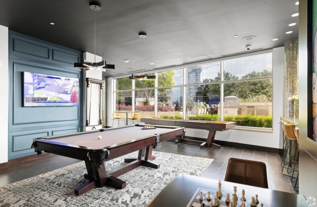 1700 Cedar Springs Road, Unit 2501 Dallas, TX 75201 - Photo 21 of 31 a living room with furniture pool table and a floor to ceiling window
