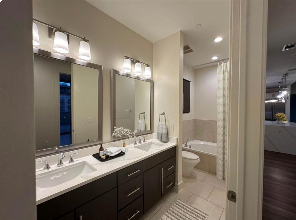 1700 Cedar Springs Road, Unit 2501 Dallas, TX 75201 - Photo 8 of 31 a bathroom with a sink double vanity and a mirror