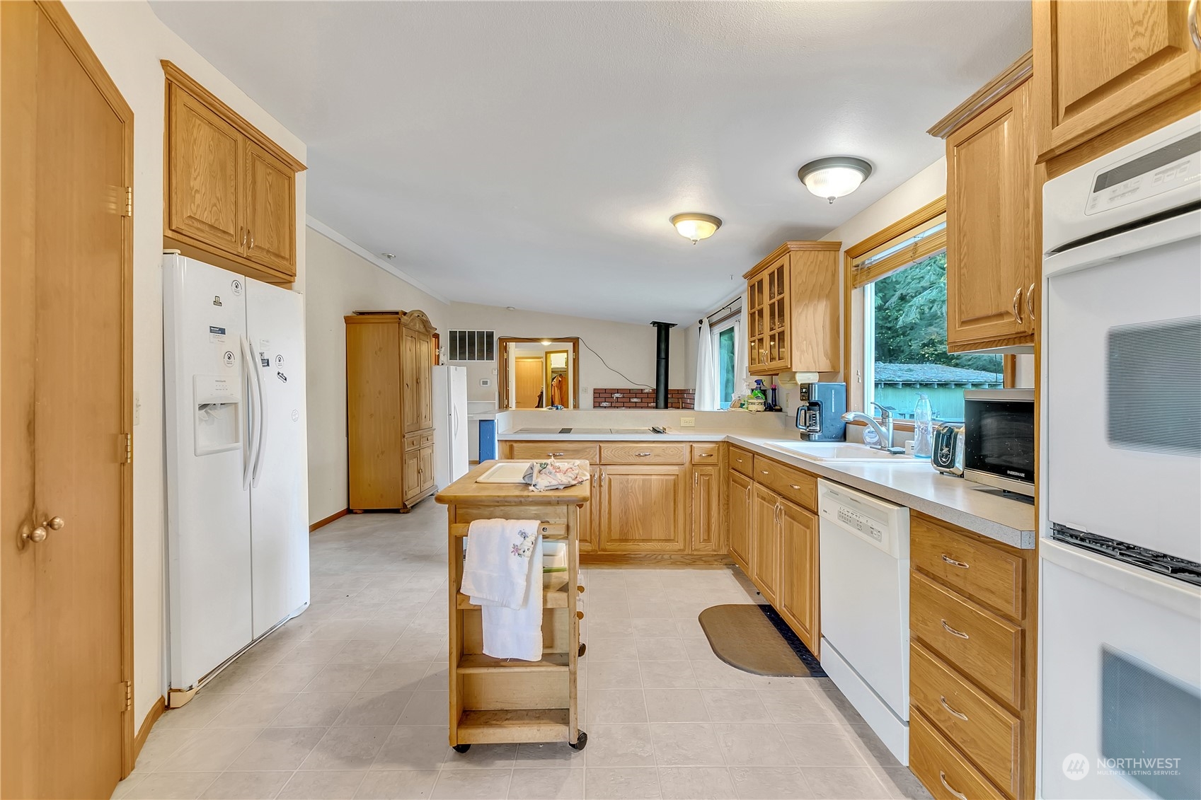 8198 Lusk Road Concrete, WA 98237 - Photo 11 of 36 a large white kitchen with sink and refrigerator