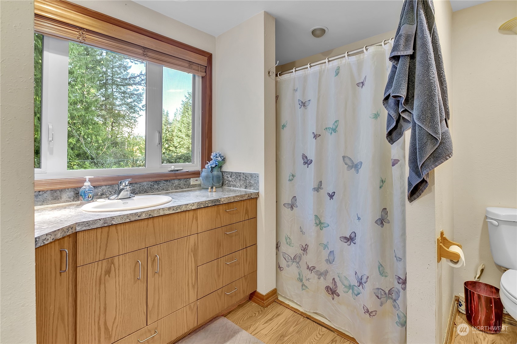 8198 Lusk Road Concrete, WA 98237 - Photo 22 of 36 a bathroom with a granite countertop sink a mirror and a shower