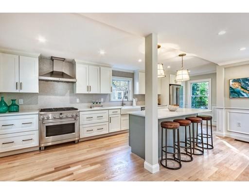 122 Pond Brook Road Newton, MA 02467 - Photo 5 of 24 a kitchen with stainless steel appliances kitchen island granite countertop a stove a sink and a refrigerator