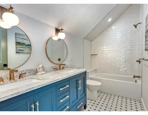 122 Pond Brook Road Newton, MA 02467 - Photo 7 of 24 a bathroom with a double vanity sink toilet mirror and shower
